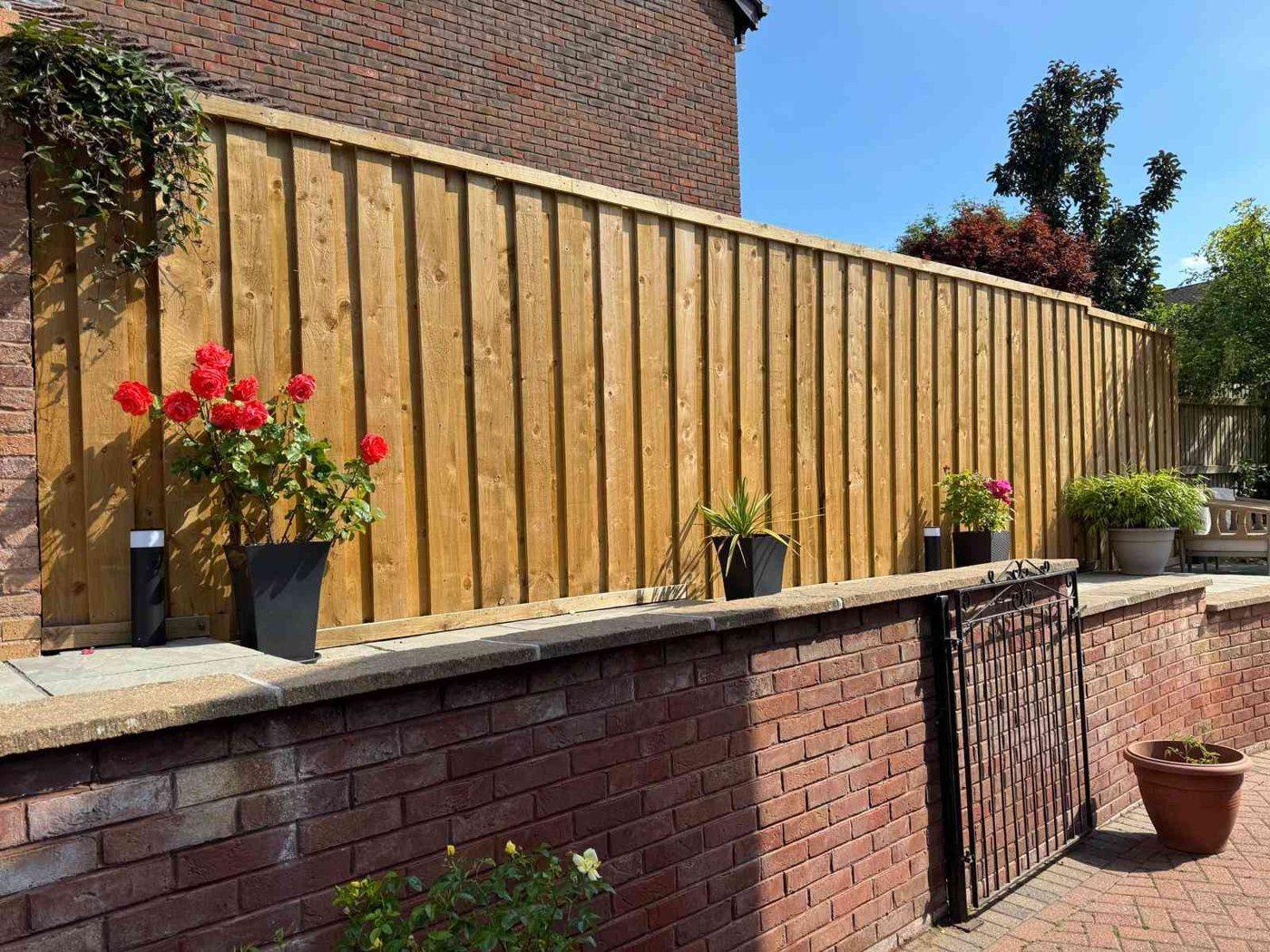 Brick retaining wall below the raised patio tier in Bramshall, near Uttoxeter