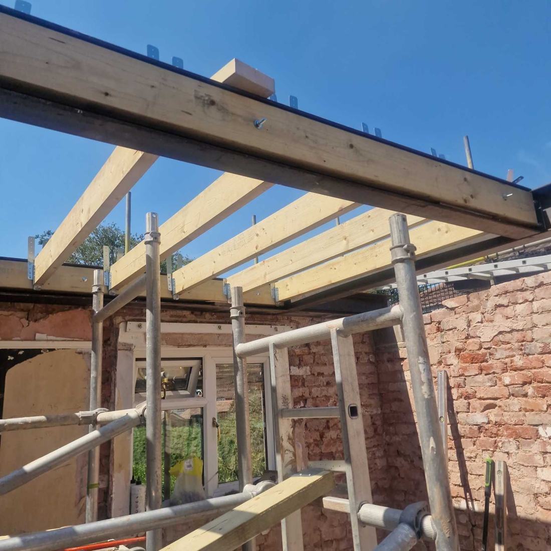 Steel beams fitted and new timber joists hung for the dormer, during a hip-to-gable and dormer loft conversion in Little Haywood